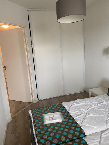 a room with a bed with a tray on it at Mimizan plage Balcon des pêcheurs in Mimizan-Plage