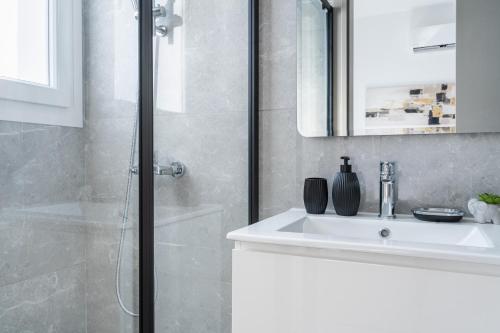 a white bathroom with a shower and a sink at Doria 2-Bedroom Apartment & Balcony in Larnaca in Aradhippou