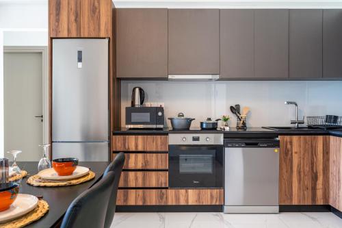 a kitchen with a table and a refrigerator at Doria 2-Bedroom Apartment & Balcony in Larnaca in Aradhippou