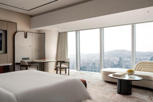 a hotel room with a bed and a large window at Four Seasons Hotel Guangzhou - Free Shuttle Bus to Canton Fair Complex & Overseas Buyer Registration Services during Canton Fair Period in Guangzhou