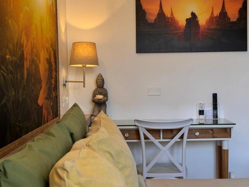 a living room with a couch and a desk at BioBenessere Eco-B&B -Adults Only- Moto&Bike Parking in Arezzo