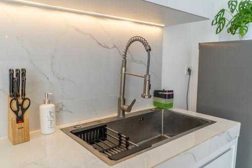 a kitchen with a sink in a counter top at Sunrise Bliss 15 Ricefield View Private Pool Villa By Bali Bliss Properties in Dalung