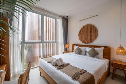 a bedroom with a bed and a large window at Sunrise Bliss 15 Ricefield View Private Pool Villa By Bali Bliss Properties in Dalung