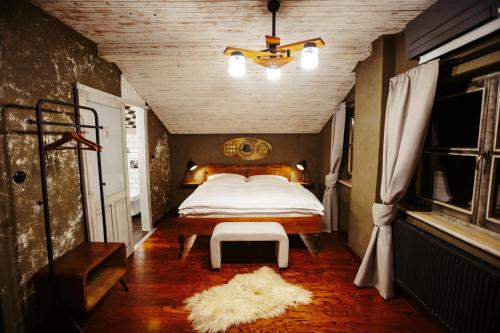 a bedroom with a bed and a chair in it at Pepin Stay in Topoľčany