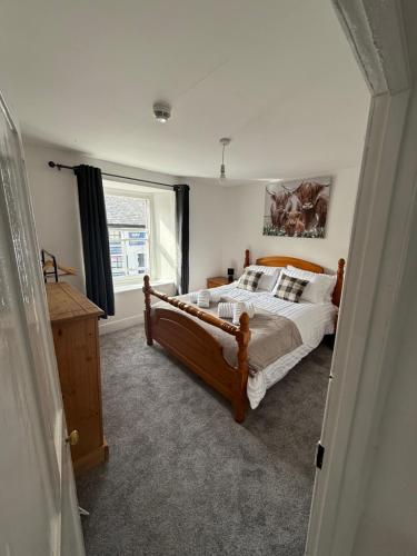 a bedroom with a large bed and a window at The Mason arms in Camelford