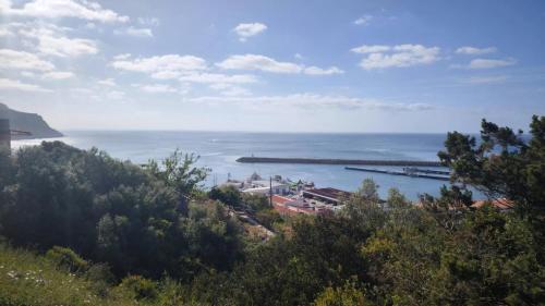 a view of the ocean from a hill at Peaceful Garden Cottage -Walking to the Beach in Bicas