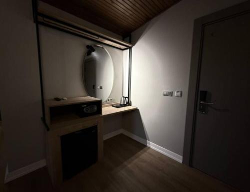 a small room with a mirror and a door at OTTO X Hotel in Kavaklıdere