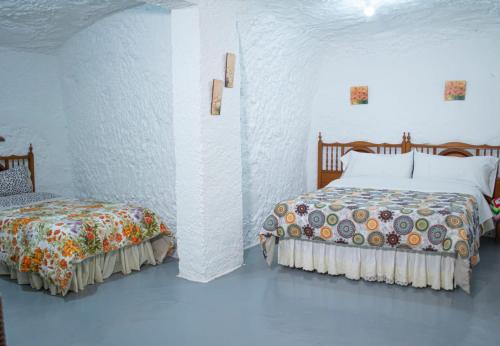 Ένα ή περισσότερα κρεβάτια σε δωμάτιο στο Cueva Navarro
