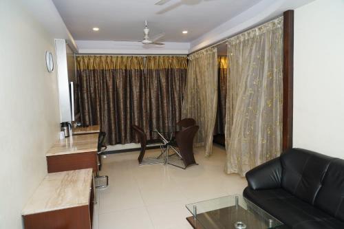 a living room with a couch and a table at Marshall The Grand Hotel in Ahmedabad