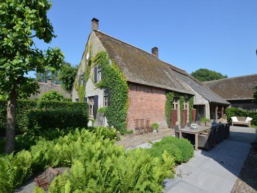 an old brick house with ivy growing on it at Group Stay with Private Pool and Sauna in Alphen