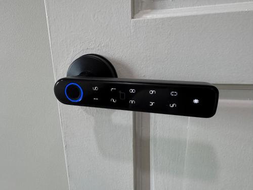 a black remote control is attached to a door at Blue Moon House in Tawau