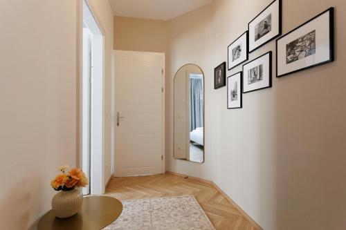 a living room with a table and a mirror at Urban Hideaway Vienna in Vienna