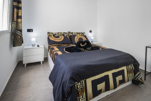 a bedroom with a bed with a blue and gold bedspread at Apartamento Alba Lanzarote in Puerto del Carmen