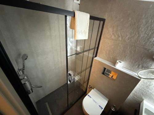 a small bathroom with a toilet and a shower at OTTO X Hotel in Kavaklıdere