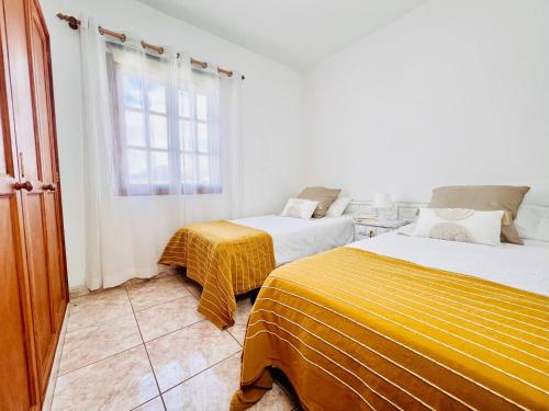 a bedroom with two beds and a window at Vista Paraiso in Tías