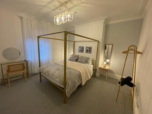 a bedroom with a canopy bed in a room at Seaglass No2 - Luxury 3 bed with optional hot tub in Seaham