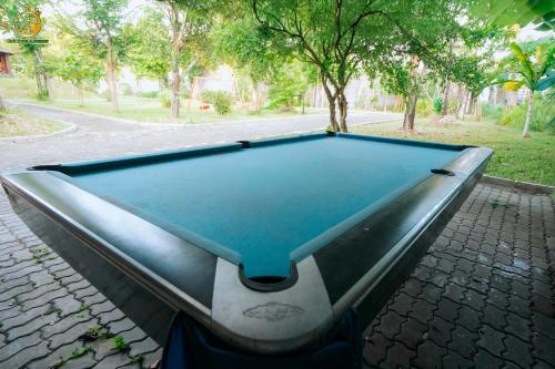 a pool table sitting on a cobblestone street at Ume Hotel & Retreat in Bóng Suối
