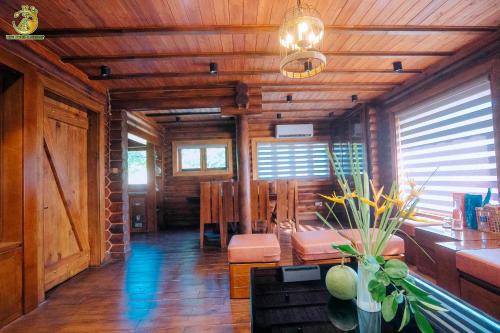 a living room with wooden walls and a wooden ceiling at Ume Hotel & Retreat in Bóng Suối