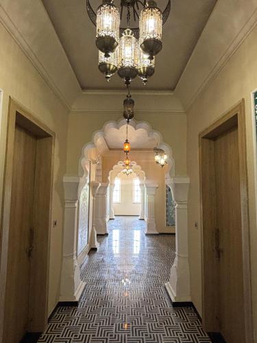 a hallway of a building with a chandelier at Chokha Dhaba in Mahwah