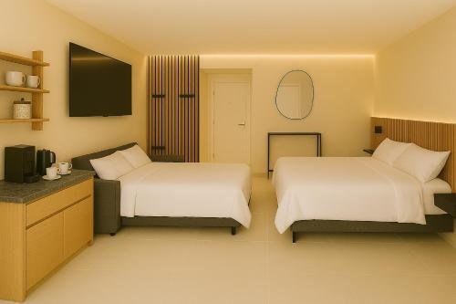 En eller flere senge i et værelse på Escala - Family Room