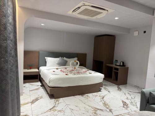 a hotel room with a bed with flowers on it at Chandi Haveli in Khed