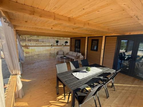 a patio with a table and chairs on a deck at The Nest in Drage