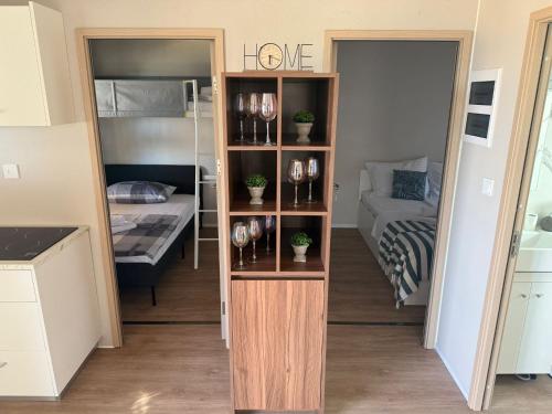 a room with a book shelf with wine glasses at The Nest in Drage