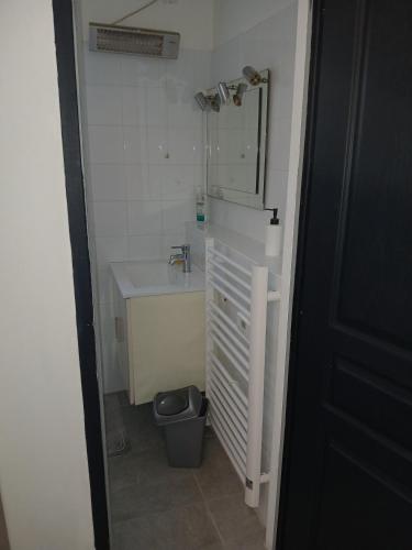 a bathroom with a sink and a toilet and a mirror at Chambre avec SDB WC à 100 m du départ du GR20 in Calenzana