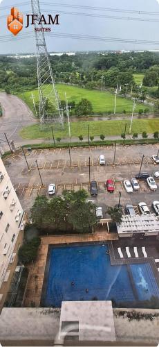 an aerial view of a parking lot with a pool at JFam Suites, C3-9D Studio, Up To 4 Pax in Biñan