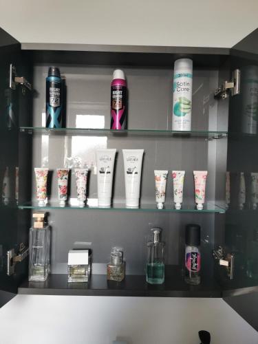 a shelf with several bottles ofodorizers and candles at No.3 in Cardiff