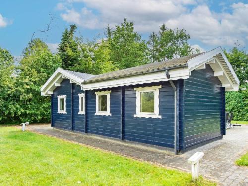 a blue tiny house in a yard at 6 person holiday home in Silkeborg-By Traum in Silkeborg