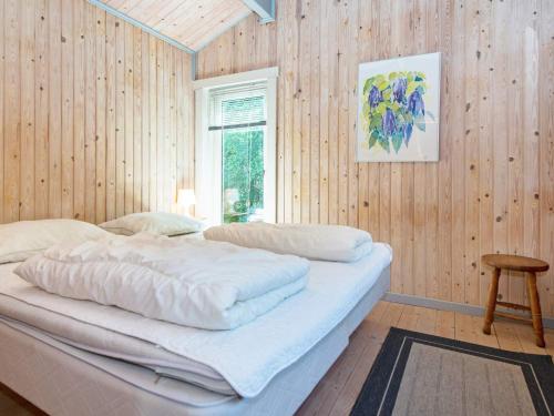 a bedroom with two beds in a wooden wall at 6 person holiday home in Silkeborg-By Traum in Silkeborg