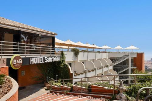 a hotel with a sign on the side of a building at B&B HOTEL Sado Setúbal in Setúbal