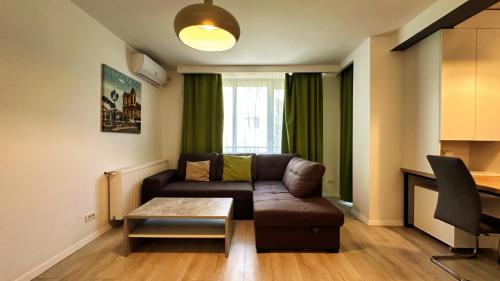 a living room with a couch and a table at Timisoara Prime Residence - powered by NEO - private parking in Timişoara