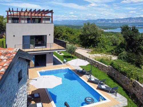 a villa with a swimming pool and a house at Villa Le Maris by Interhome in Dobrinj