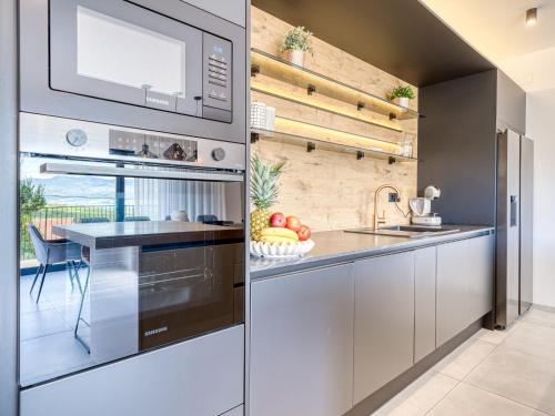 a kitchen with a sink and a microwave at Villa Le Maris by Interhome in Dobrinj