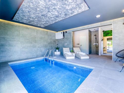a swimming pool in a house with a blue ceiling at Villa Le Maris by Interhome in Dobrinj