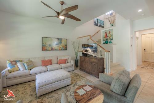 a living room with a couch and a ceiling fan at 2BR bright quiet condo in Kulalani sleeps 6 in Waikoloa
