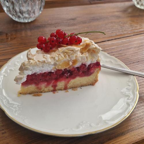 a piece of cake on a white plate with a fork at Willa Marysin in Maków Podhalański