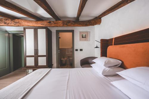 a bedroom with a large white bed and a window at Boutique Hotel San Rocco in Brtonigla