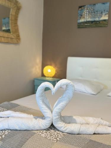 two towels in the shape of a heart on a bed at Sykia Itamos Studio-2 in Sykia Chalkidikis
