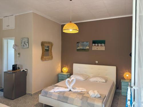 a bedroom with a bed with two towels on it at Sykia Itamos Studio-2 in Sykia Chalkidikis