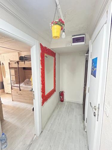 a hallway of a room with a mirror and a bed at 3 rooms studios in Istanbul