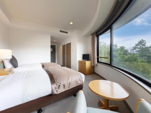 Ein Bett oder Betten in einem Zimmer der Unterkunft Evergreen-Fuji