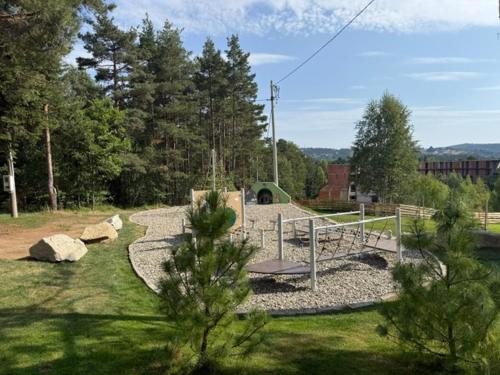 a park with a bench in the middle of a yard at Angelina Apart Hotel&Spa in Divčibare