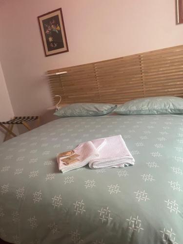 a towel on a bed with a purse on it at COZY Place 26 in Vercelli