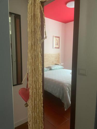 a bedroom with a bed with a red ceiling at COZY Place 26 in Vercelli