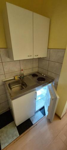 a small kitchen with a sink and a stove at Apartmani Jelena in Neum