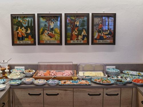 a buffet with many plates of food and pictures on the wall at Hametner mit Innviertlerhaus mit Thermenzugang in Bad Hall