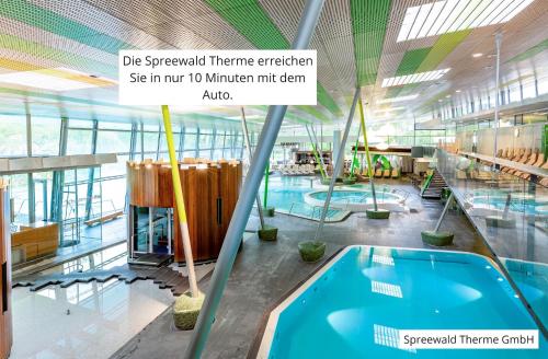 a pool in a building with a swimming pool at Spreewald Pension Spreeaue in Burg
